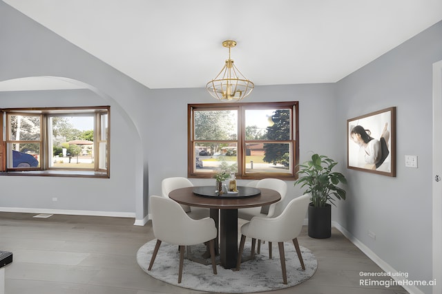 26W278 Harrison Ave, Winfield, IL 60190 - dining space with arched walkways, a chandelier, and wood finished floors