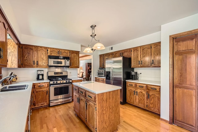 3825 Charlemagne Dr, Hoffman Estates, IL 60192 - kitchen with appliances with stainless steel finishes, a kitchen island, light wood finished floors, light countertops, and brown cabinets