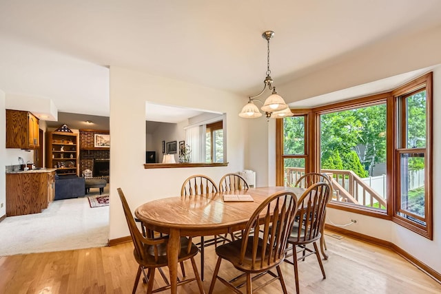 3825 Charlemagne Dr, Hoffman Estates, IL 60192 - dining area featuring healthy amount of natural light, a brick fireplace, and light wood-type flooring