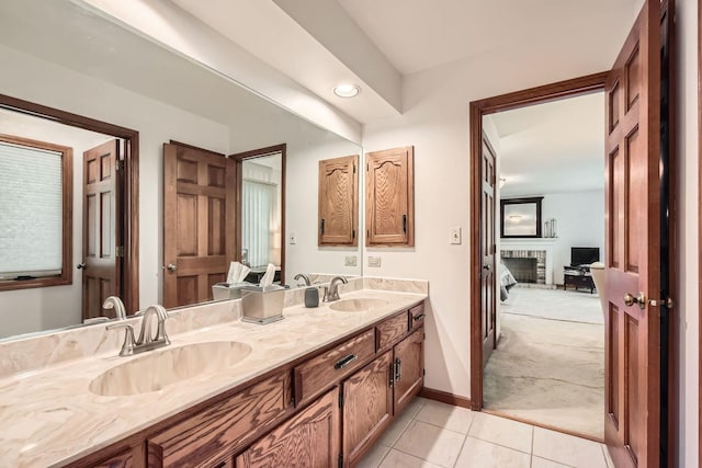 3825 Charlemagne Dr, Hoffman Estates, IL 60192 - bathroom featuring double vanity, tile patterned floors, a brick fireplace, and recessed lighting