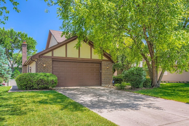 3825 Charlemagne Dr, Hoffman Estates, IL 60192 - view of front facade with brick siding, an attached garage, a front lawn, concrete driveway, and a chimney