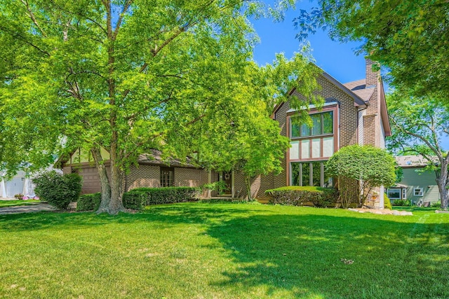 3825 Charlemagne Dr, Hoffman Estates, IL 60192 - view of front of home featuring a front lawn, a chimney, and brick siding