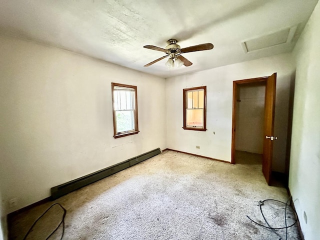 673 Parkway Ave, Elgin, IL 60120 - unfurnished bedroom with a baseboard heating unit, attic access, light carpet, and ceiling fan
