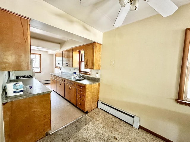 673 Parkway Ave, Elgin, IL 60120 - kitchen with a baseboard heating unit, brown cabinetry, and ceiling fan