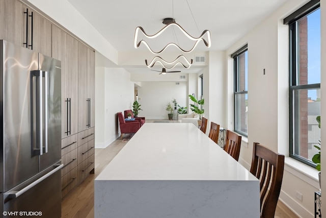 1261 N Paulina Ave Unit 6, Chicago, IL 60622 - dining space featuring light wood finished floors, healthy amount of natural light, and a chandelier