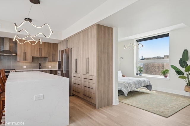 1261 N Paulina Ave Unit 6, Chicago, IL 60622 - kitchen featuring wall chimney range hood, high end refrigerator, light countertops, and light wood finished floors