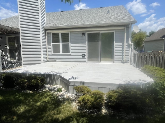 1827 Arbor Falls Dr, Plainfield, IL 60586 - back of property featuring a shingled roof, a wooden deck, and a chimney