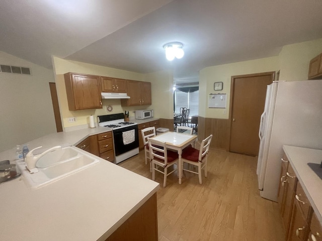 1827 Arbor Falls Dr, Plainfield, IL 60586 - kitchen featuring white appliances, light wood finished floors, brown cabinetry, under cabinet range hood, and light countertops