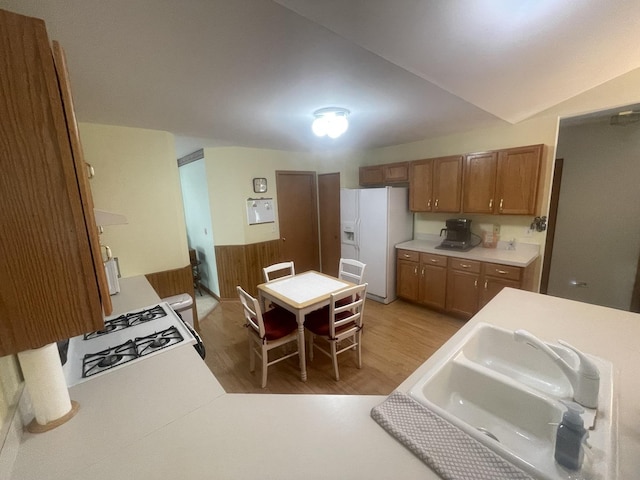 1827 Arbor Falls Dr, Plainfield, IL 60586 - kitchen with white refrigerator with ice dispenser, brown cabinetry, light wood-style flooring, and light countertops
