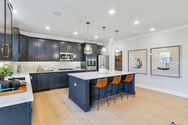 6 Hawthorn Ridge Dr, Hawthorn Woods, IL 60047 - kitchen featuring appliances with stainless steel finishes, a breakfast bar, a kitchen island, crown molding, and light wood-style flooring
