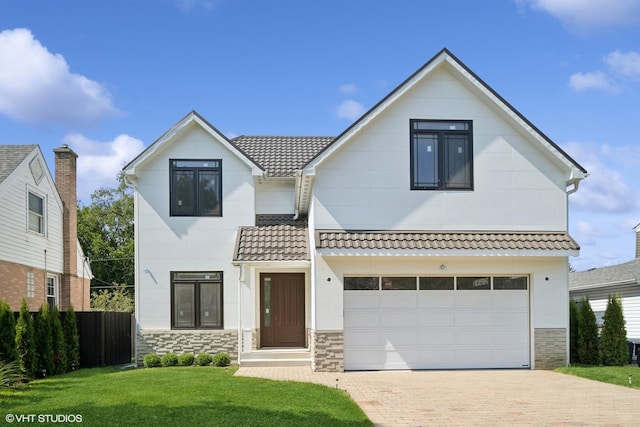 124 Lincoln St, Glenview, IL 60025 - view of front of home with stone siding, decorative driveway, an attached garage, and a tile roof