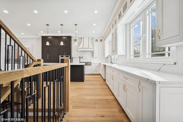124 Lincoln St, Glenview, IL 60025 - kitchen with premium range hood, stainless steel appliances, light wood finished floors, white cabinetry, and recessed lighting