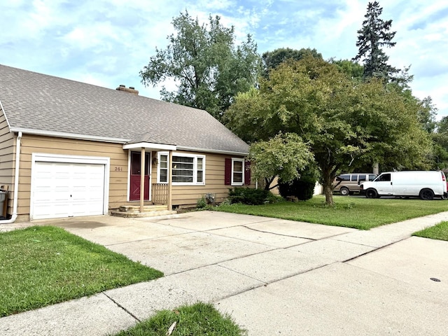 261 S Edison Ave, Elgin, IL 60123 - view of front of home with driveway, a front lawn, a garage, and roof with shingles