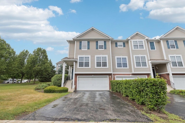 515 Declaration Ln Unit 1401, Aurora, IL 60502 - view of front of home with a garage, driveway, a front lawn, and brick siding