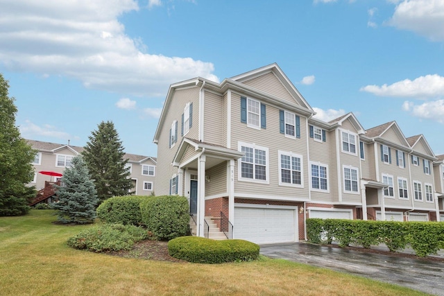 515 Declaration Ln Unit 1401, Aurora, IL 60502 - townhome / multi-family property with a garage, driveway, a front lawn, and a residential view