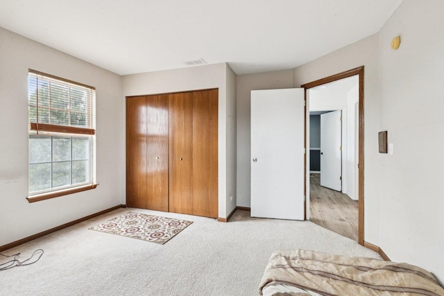 515 Declaration Ln Unit 1401, Aurora, IL 60502 - unfurnished bedroom with light carpet and a closet