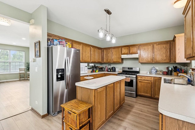 515 Declaration Ln Unit 1401, Aurora, IL 60502 - kitchen with appliances with stainless steel finishes, under cabinet range hood, light countertops, brown cabinetry, and a center island