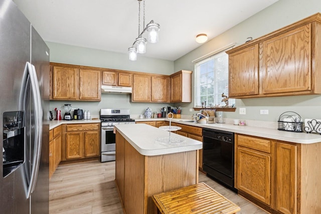 515 Declaration Ln Unit 1401, Aurora, IL 60502 - kitchen with appliances with stainless steel finishes, under cabinet range hood, light countertops, light wood-type flooring, and decorative light fixtures