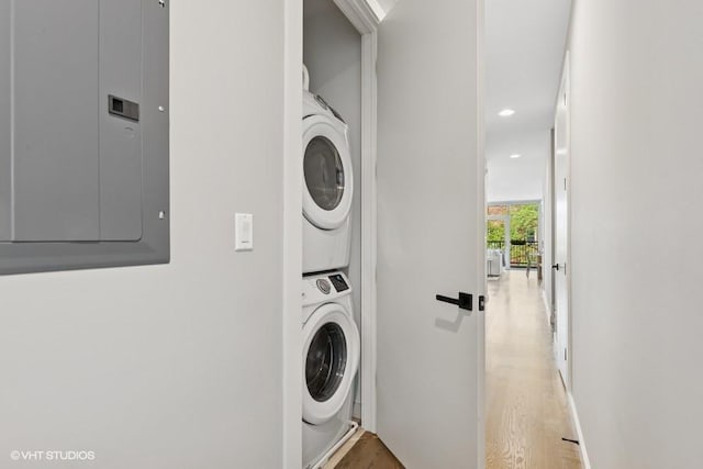 2237 N Hoyne Ave Unit 3S, Chicago, IL 60647 - laundry room with stacked washer and clothes dryer, electric panel, light wood-type flooring, and recessed lighting