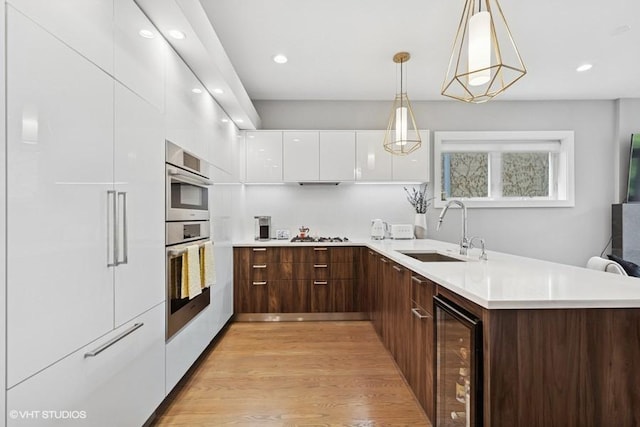 2237 N Hoyne Ave Unit 3S, Chicago, IL 60647 - kitchen featuring modern cabinets, wine cooler, white cabinets, light countertops, and a peninsula
