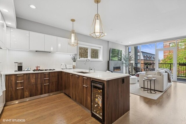 2237 N Hoyne Ave Unit 3S, Chicago, IL 60647 - kitchen with beverage cooler, light wood-type flooring, modern cabinets, white cabinetry, and light countertops