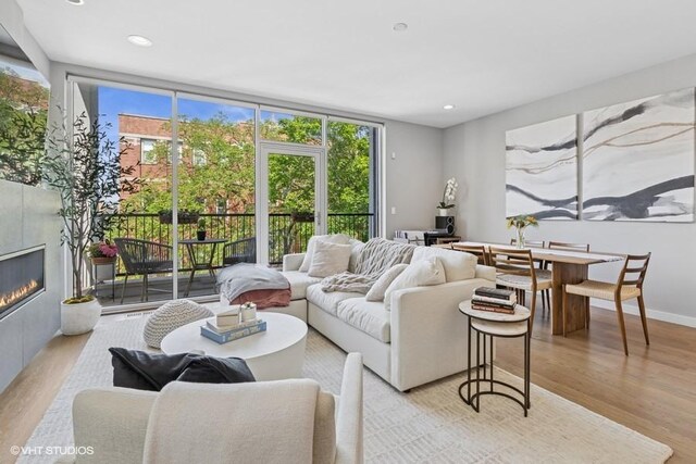 2237 N Hoyne Ave Unit 3S, Chicago, IL 60647 - living room featuring light wood-type flooring, a glass covered fireplace, and recessed lighting