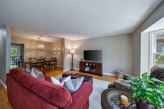 74 White Oak Cir, Saint Charles, IL 60174 - living room with wood finished floors, plenty of natural light, and a chandelier