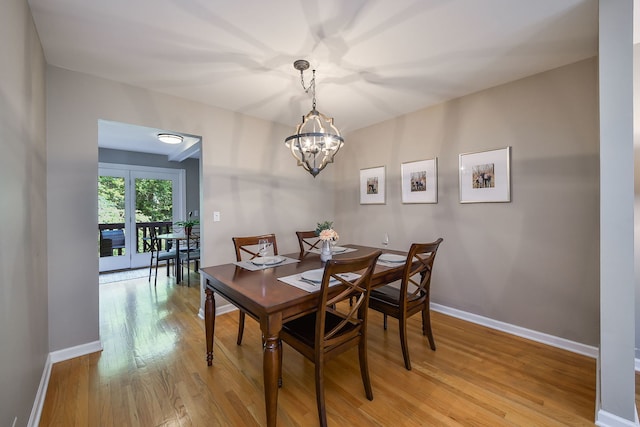 74 White Oak Cir, Saint Charles, IL 60174 - dining room with light wood-style flooring and a chandelier