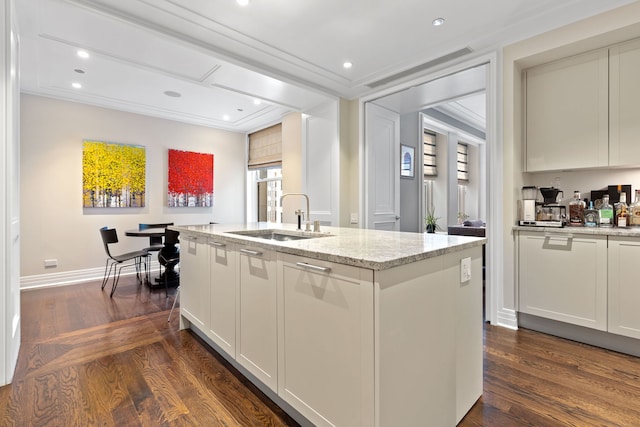 159 E Walton Pl Unit 5C, Chicago, IL 60611 - kitchen featuring dark wood finished floors, light stone counters, an island with sink, recessed lighting, and white cabinets