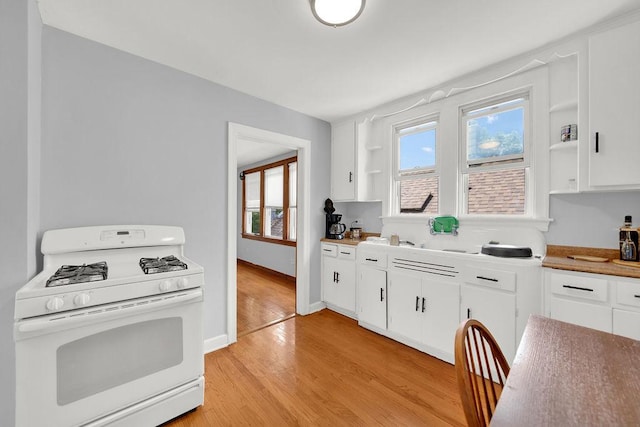 3209 S Harding Ave, Chicago, IL 60623 - kitchen featuring gas range gas stove, open shelves, light wood-type flooring, and white cabinets