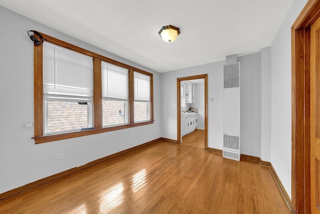 3209 S Harding Ave, Chicago, IL 60623 - empty room with a heating unit and light wood-style flooring