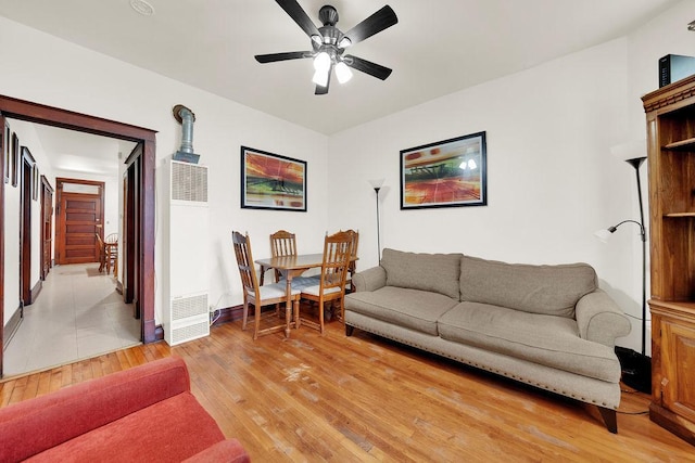3209 S Harding Ave, Chicago, IL 60623 - living area with a heating unit, light wood-style flooring, and a ceiling fan