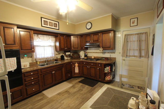 9701 Illinois St, Hebron, IL 60034 - kitchen with under cabinet range hood, black appliances, a ceiling fan, crown molding, and backsplash