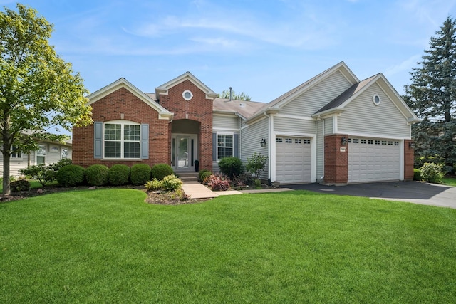 12663 Cold Springs Dr, Huntley, IL 60142 - view of front facade with brick siding, driveway, an attached garage, and a front yard