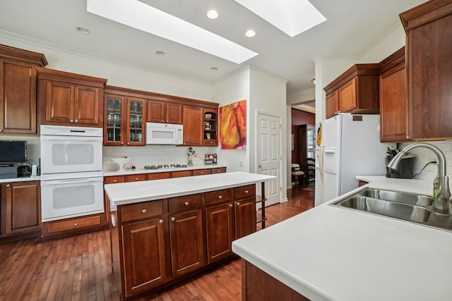12663 Cold Springs Dr, Huntley, IL 60142 - kitchen featuring white appliances, a skylight, ornamental molding, decorative backsplash, and light countertops