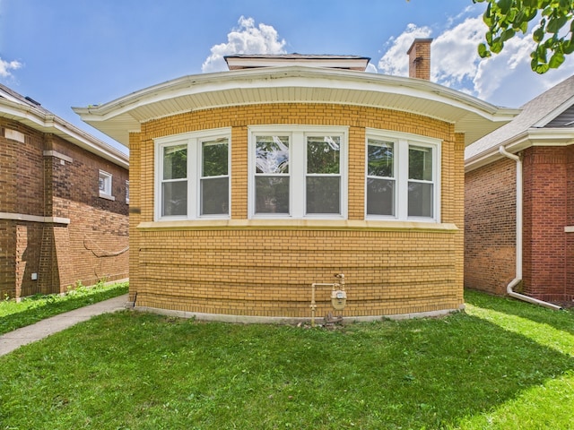 8015 S Paxton Ave, Chicago, IL 60617 - view of side of property with a yard, a chimney, and brick siding