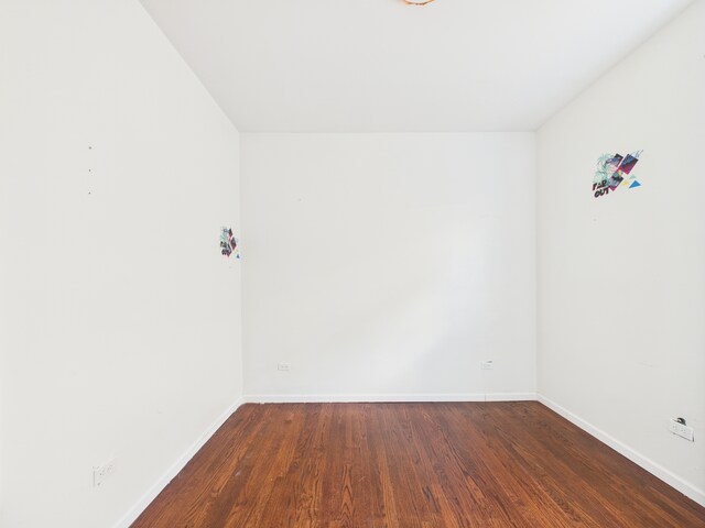 8015 S Paxton Ave, Chicago, IL 60617 - spare room featuring dark wood-style floors and baseboards