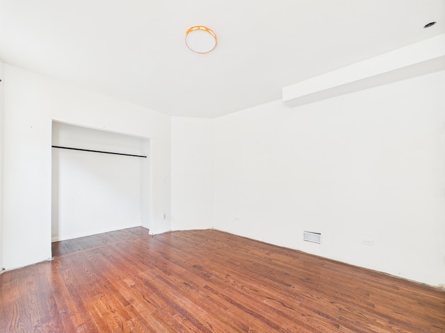 8015 S Paxton Ave, Chicago, IL 60617 - unfurnished bedroom featuring wood finished floors and a closet