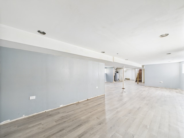 8015 S Paxton Ave, Chicago, IL 60617 - unfurnished living room with stairs, light wood-type flooring, and gas water heater