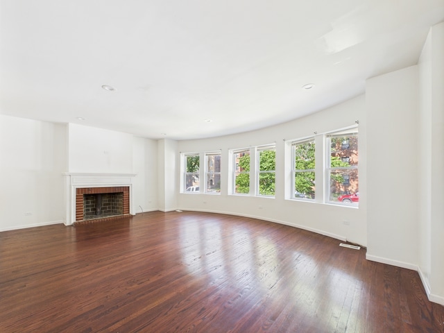 8015 S Paxton Ave, Chicago, IL 60617 - unfurnished living room with plenty of natural light, wood-type flooring, a fireplace, and recessed lighting