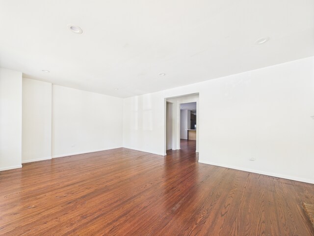 8015 S Paxton Ave, Chicago, IL 60617 - spare room featuring wood finished floors and recessed lighting
