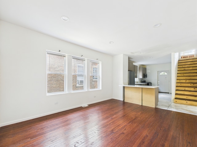 8015 S Paxton Ave, Chicago, IL 60617 - unfurnished living room with light wood-type flooring, stairs, and recessed lighting