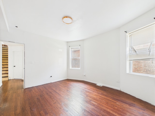 8015 S Paxton Ave, Chicago, IL 60617 - unfurnished room with healthy amount of natural light and dark wood-style floors