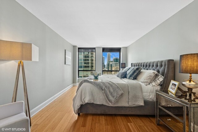 260 E Chestnut St Unit 3303, Chicago, IL 60611 - bedroom with wood finished floors and a city view