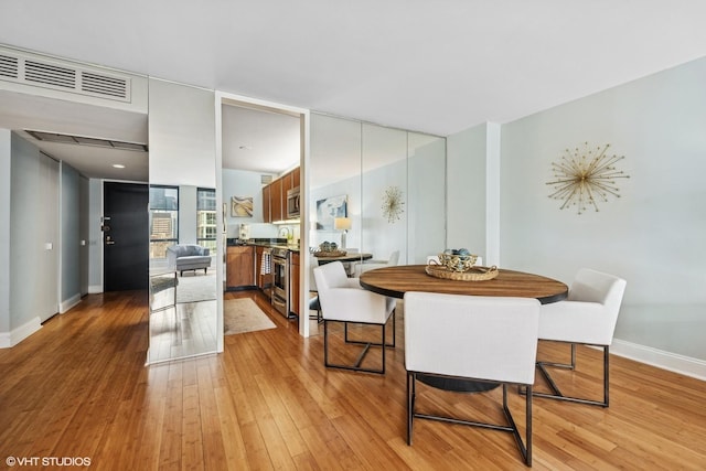 260 E Chestnut St Unit 3303, Chicago, IL 60611 - dining area with baseboards and light wood finished floors