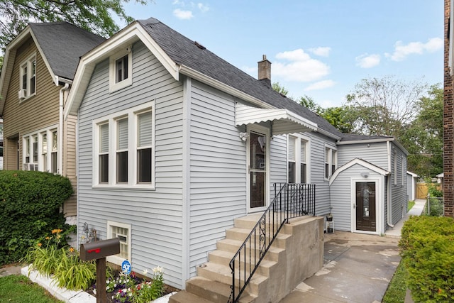 12349 S Parnell Ave, Chicago, IL 60628 - view of front facade featuring a chimney and roof with shingles