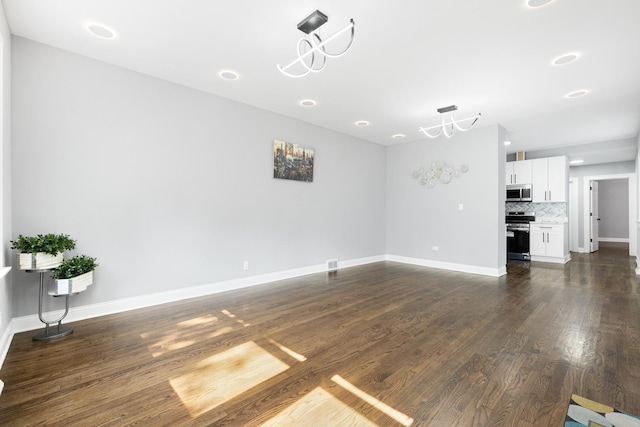 12349 S Parnell Ave, Chicago, IL 60628 - unfurnished living room featuring dark wood-style flooring and baseboards