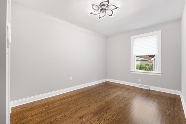 12349 S Parnell Ave, Chicago, IL 60628 - unfurnished room with dark wood-style floors and baseboards