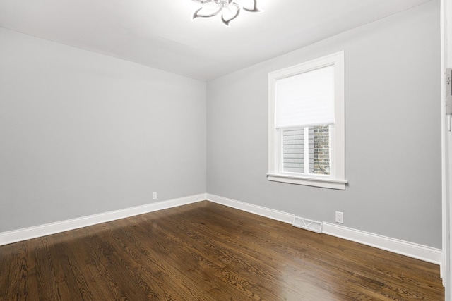 12349 S Parnell Ave, Chicago, IL 60628 - empty room featuring dark wood-type flooring and a chandelier