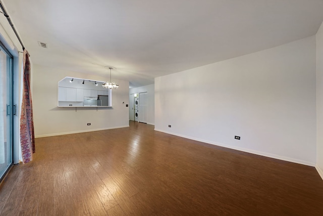 5200 N Rockwell St Unit 3N, Chicago, IL 60625 - unfurnished living room featuring a chandelier and dark wood-style flooring
